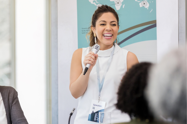 A woman talking in front of a group